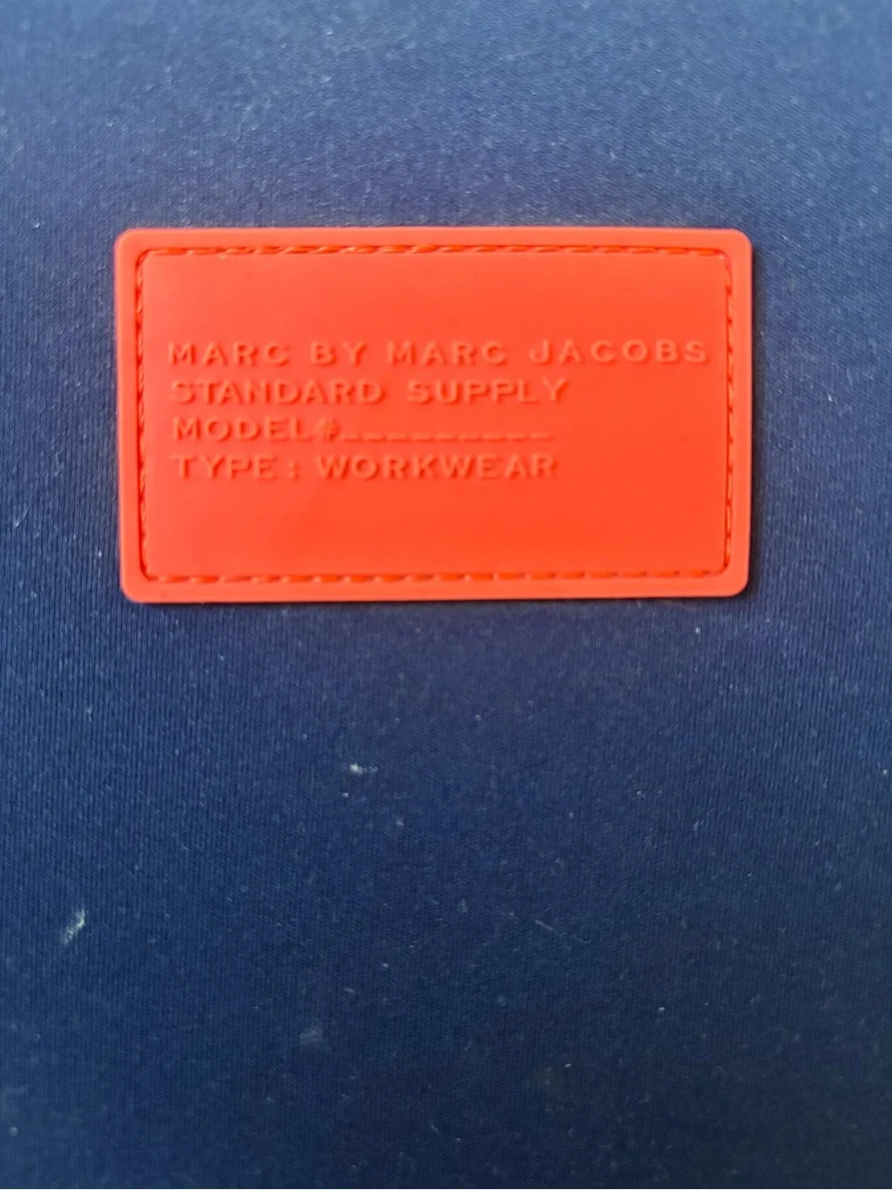 Marc by Marc Jacobs navy case with coral logo patch
